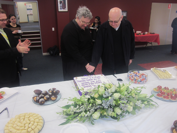 Fr Arthur and Deacon James cutting the cake