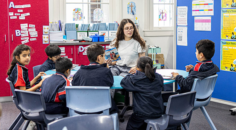Teacher with class at St Oliver’s Catholic Primary School Harris Park