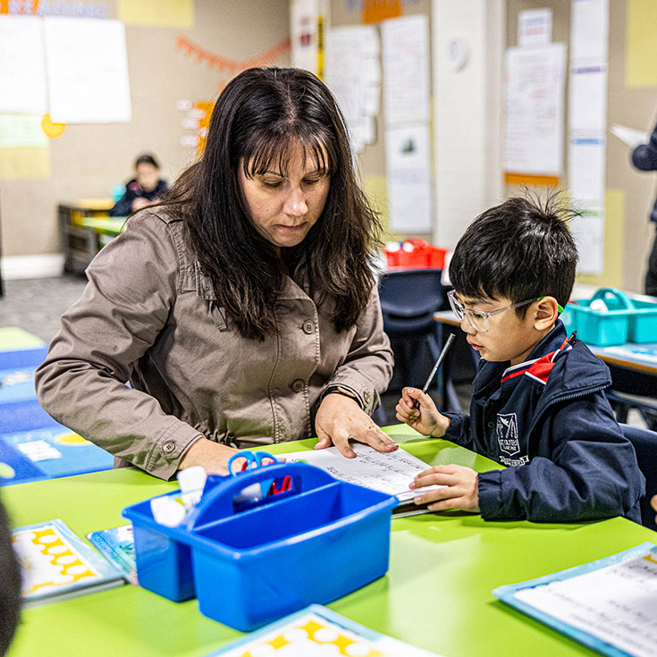 Teacher with student at St Oliver’s Catholic Primary School Harris Park